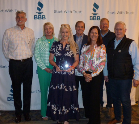 PLayCore team accepts local BBB Torch Award, which qualified them for the International Award